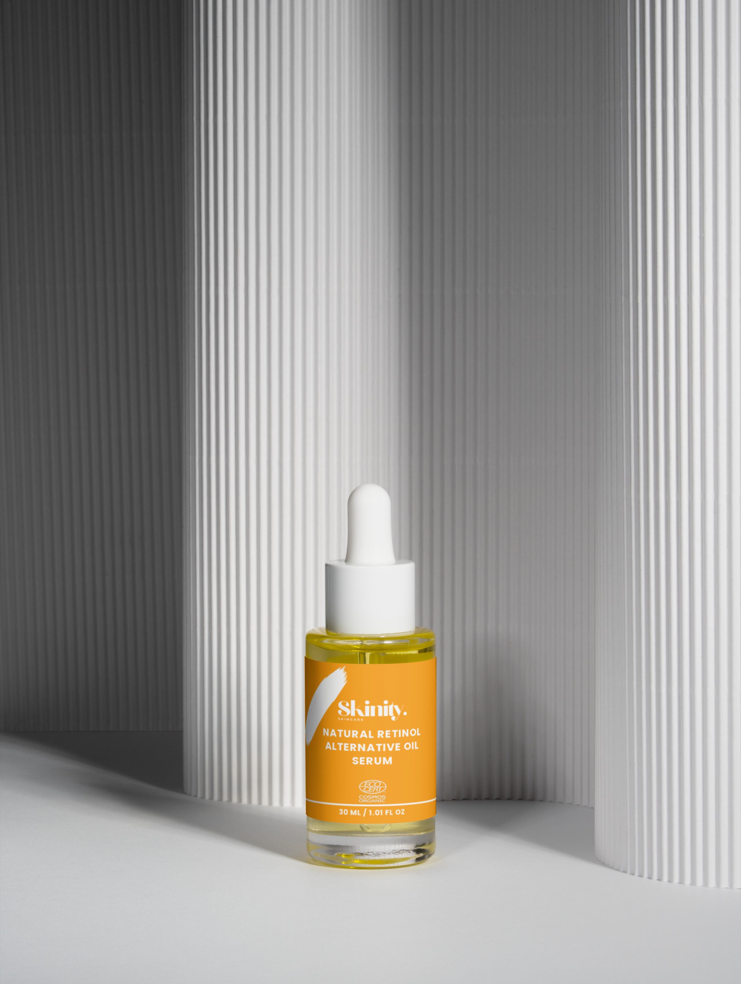 Natural Retinol Alternative Oil Serum in an elegant bottle on textured background, promoting radiant skin.