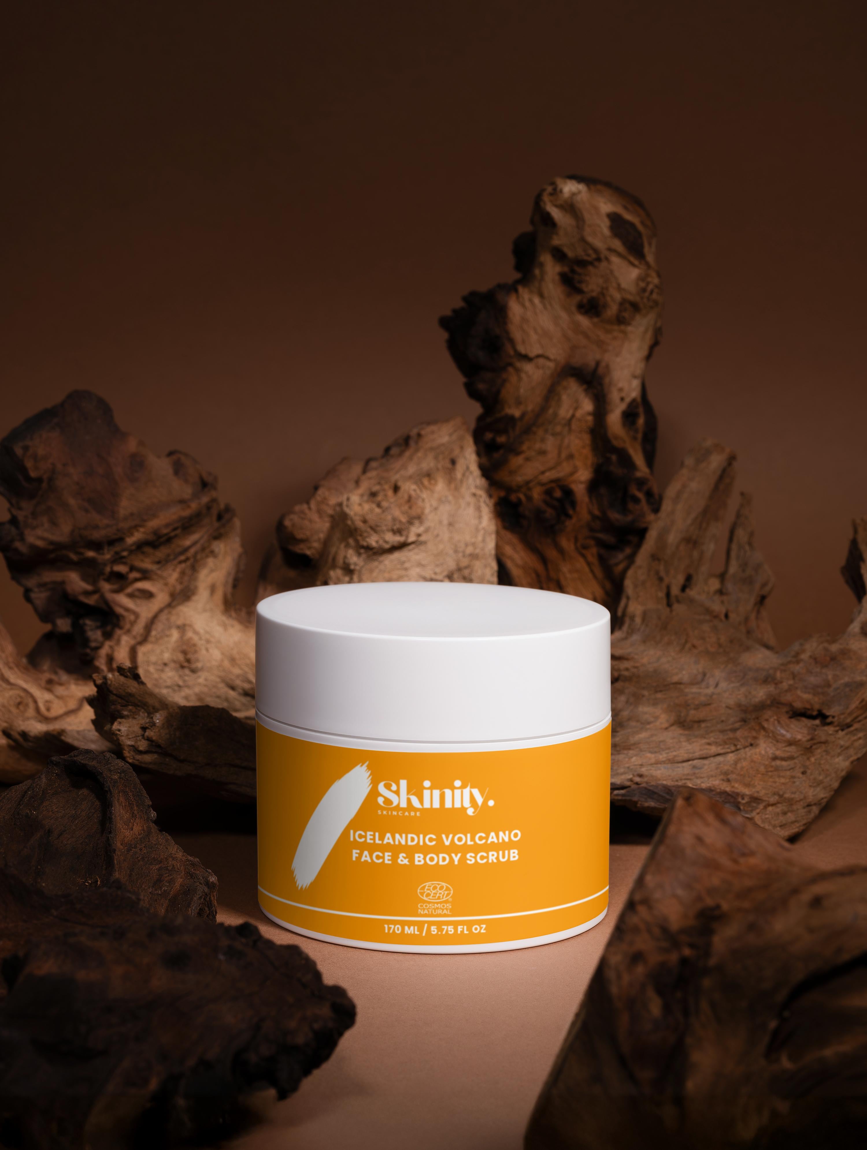 Icelandic Volcano Face and Body Scrub jar on a natural wood backdrop, showcasing skin care benefits.