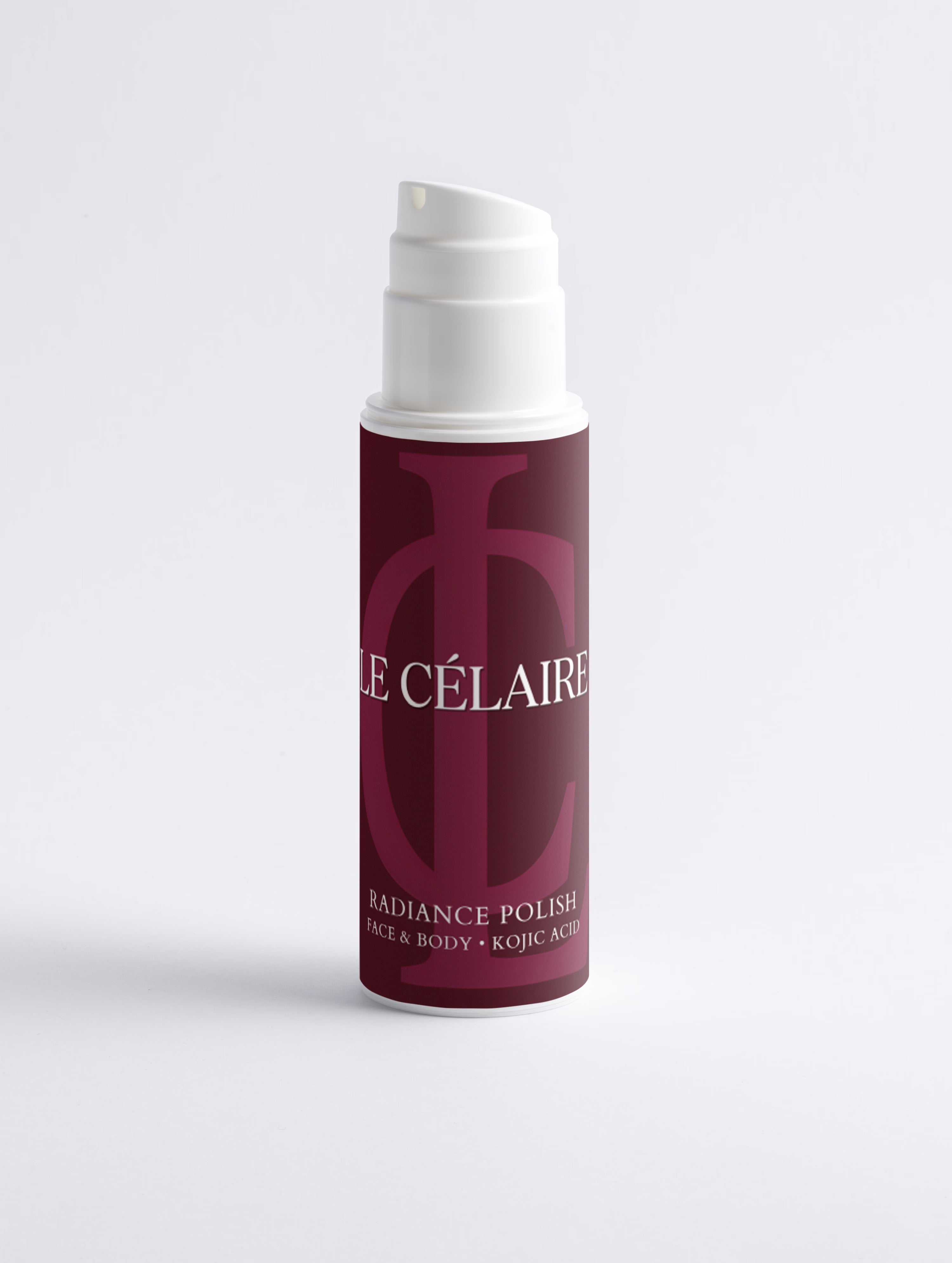 A bottle of Célaires Radiance Polish face and body polish, featuring a deep burgundy label with a large monogram and white pump dispenser, set against a clean white background.