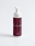 A bottle of Cle Célaire Cleansing Foam with a white pump dispenser and a deep burgundy label, set against a clean white background.