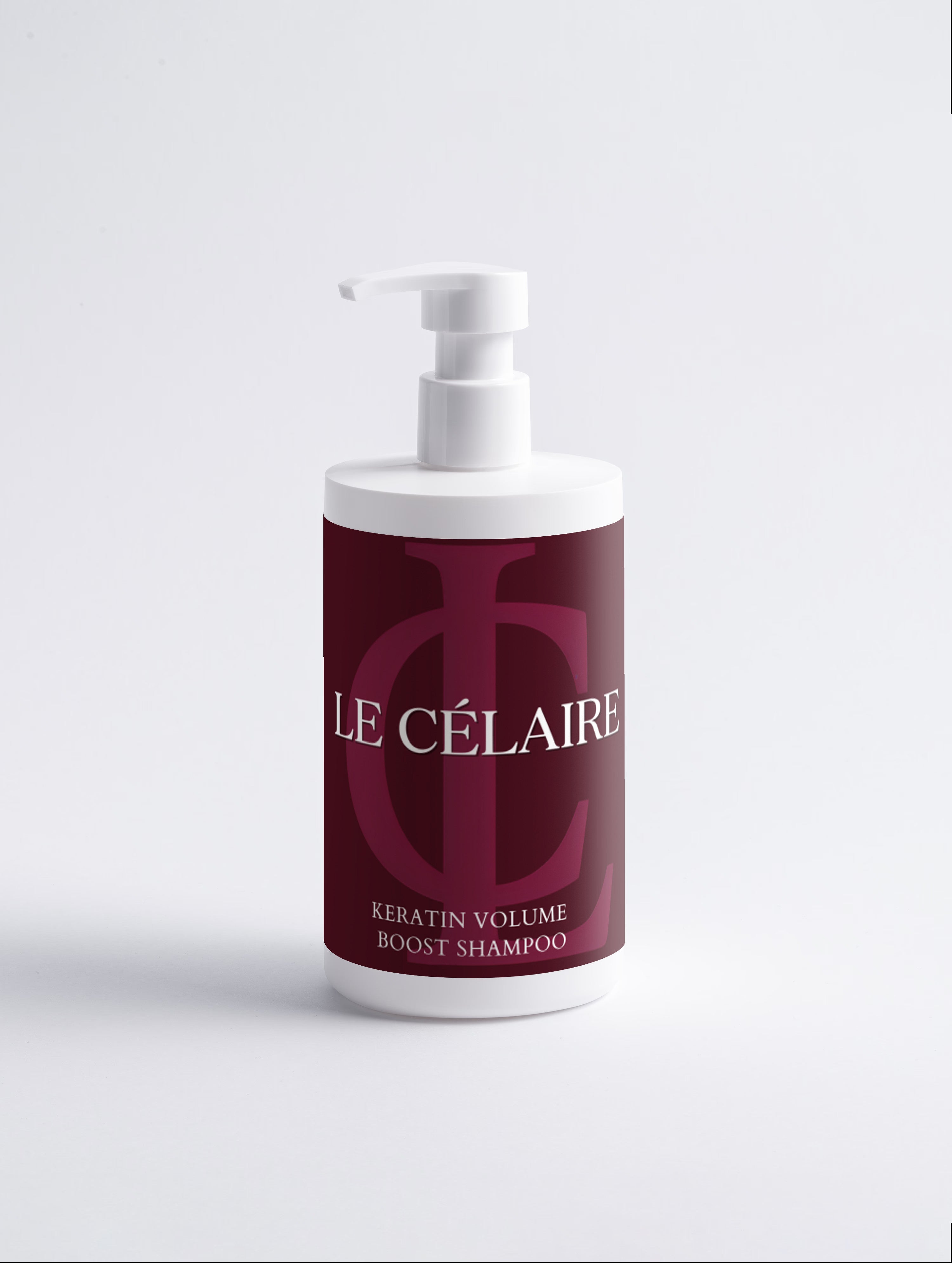 A bottle of Le Célaire Keratin Volume Boost Shampoo with a white pump dispenser and a deep burgundy label featuring a large monogram logo.