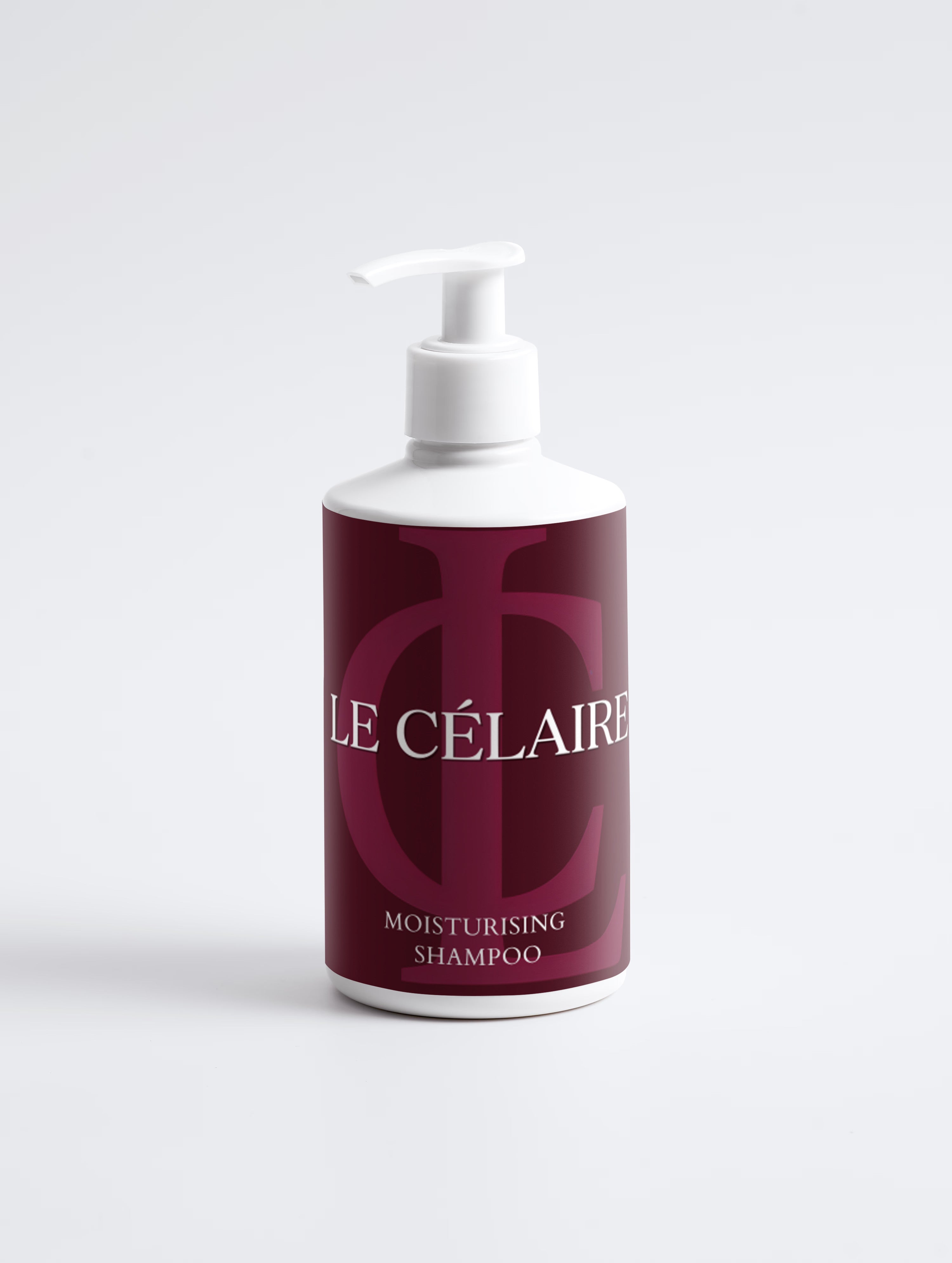 A bottle of Le Célaire Moisturising Shampoo with a white pump dispenser and a deep burgundy label featuring a large monogram logo and white text, set against a clean white background.
