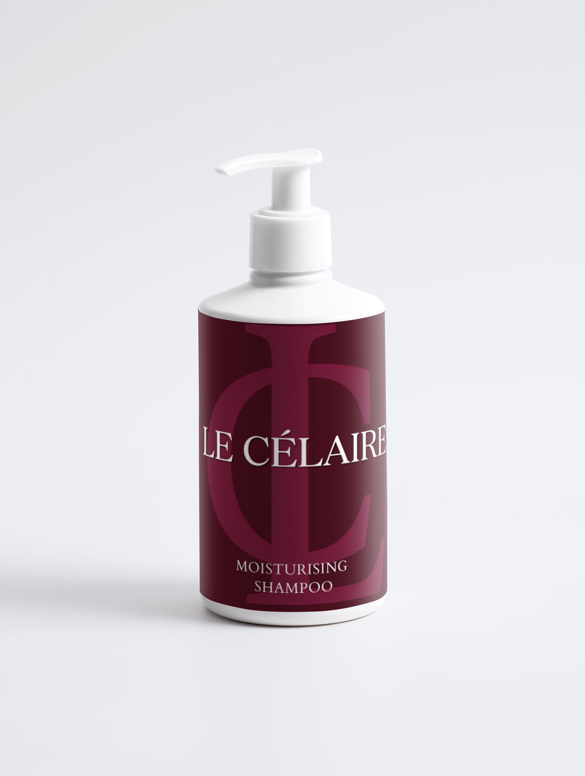A bottle of Le Célaire Moisturising Shampoo with a white pump dispenser and a deep burgundy label featuring a large monogram logo and white text, set against a clean white background.