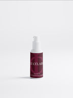 A small cosmetic pump bottle with a white pump and a deep burgundy label reading 'LE CÉLAIRE' and 'EXTINCTION ALTERNATIVE SÉRUM', centered on a clean light gray background.