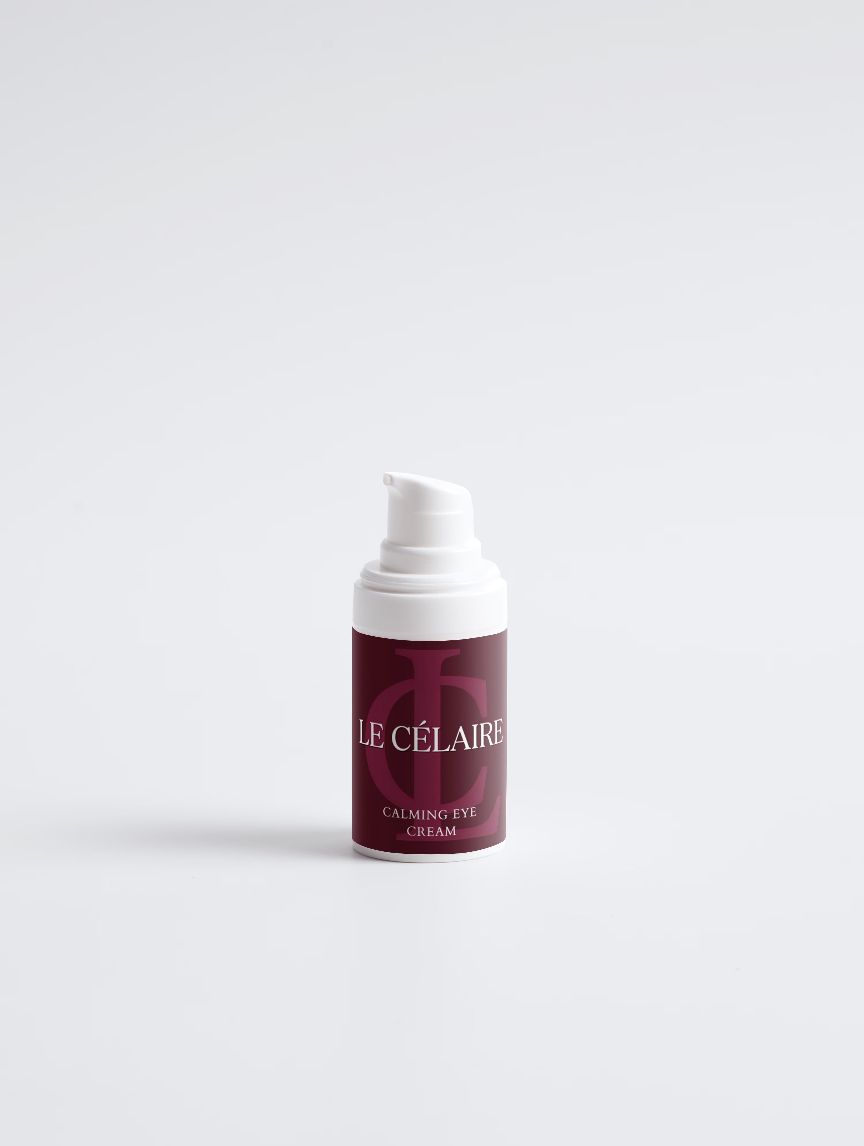 A small pump bottle of Le Célaire Calming Eye Cream, featuring a deep burgundy label with white lettering and a white pump dispenser, set against a clean white background.