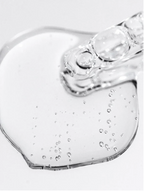 Bioactive Prebiotics Jelly Serum on a surface showing its clear, bubbly texture, highlighting its hydrating properties.