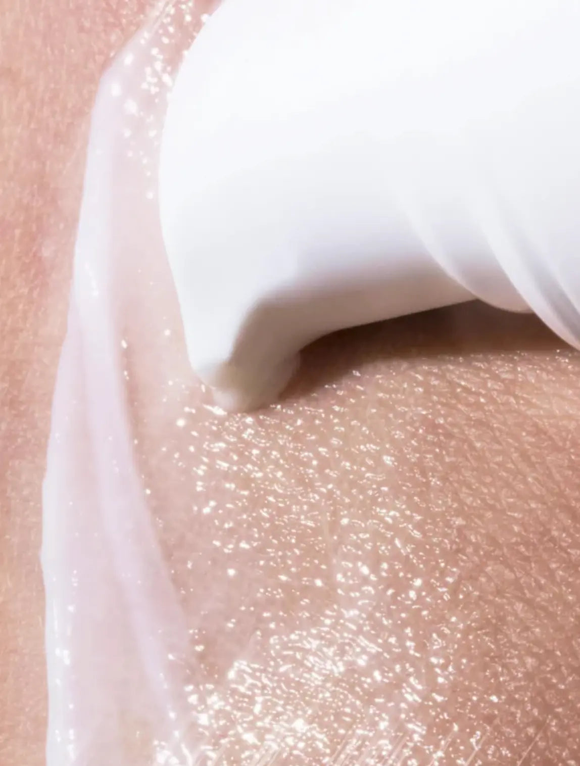 Close-up of a white applicator on a pink background