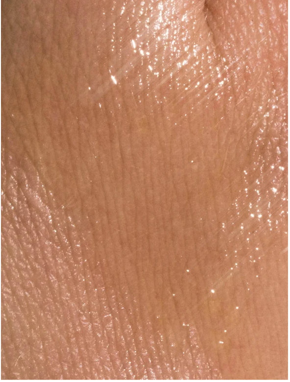 Close-up of skin with nourishing facial oil for all skin, showcasing a healthy glow and hydration.