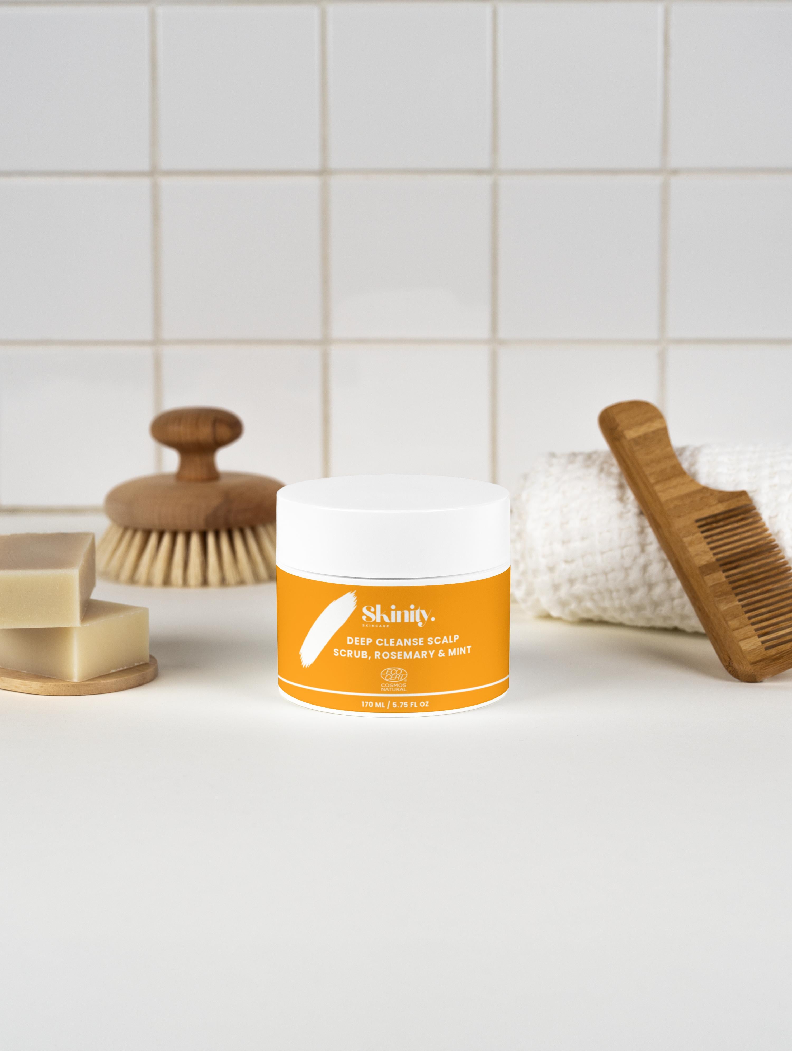 Deep Cleanse Scalp Scrub Rosemary and Mint product with tools on a clean countertop.