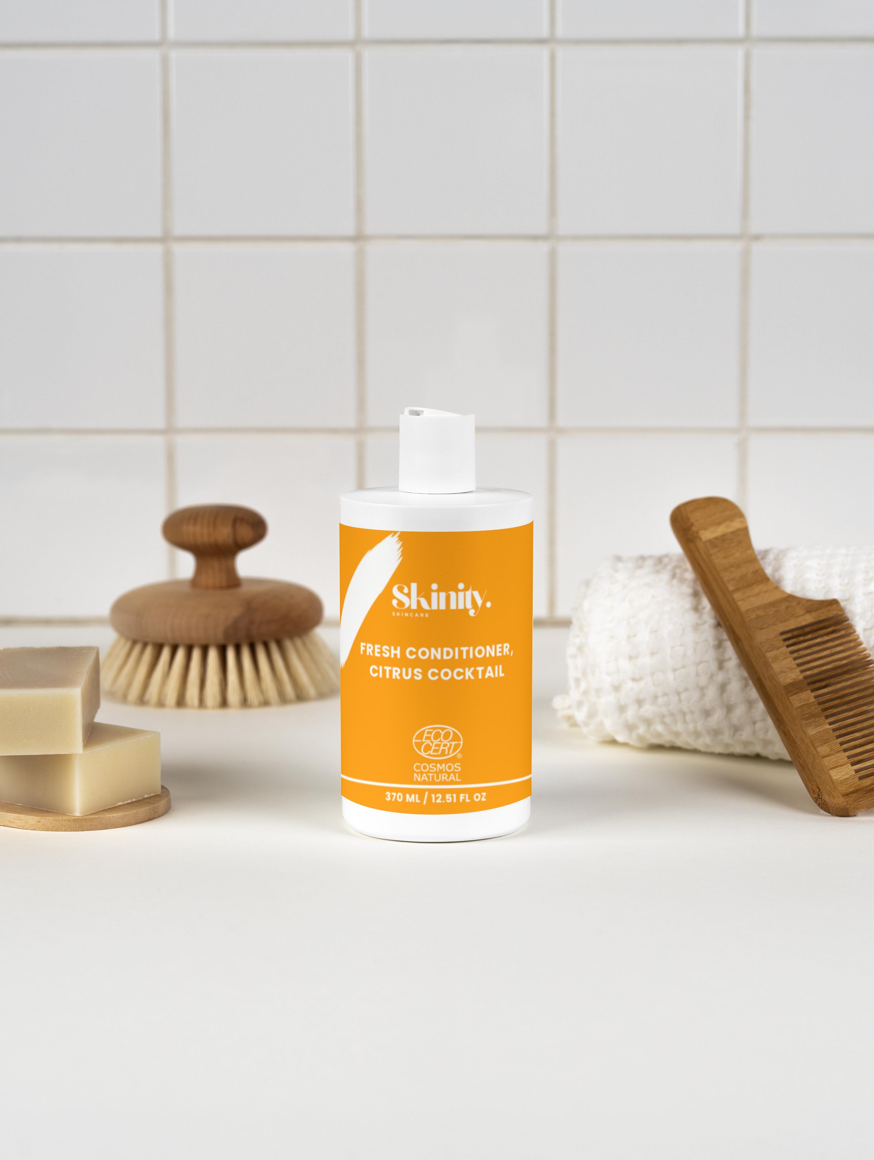 Fresh Conditioner Citrus Cocktail bottle on a minimalist bathroom counter with grooming tools and soap.