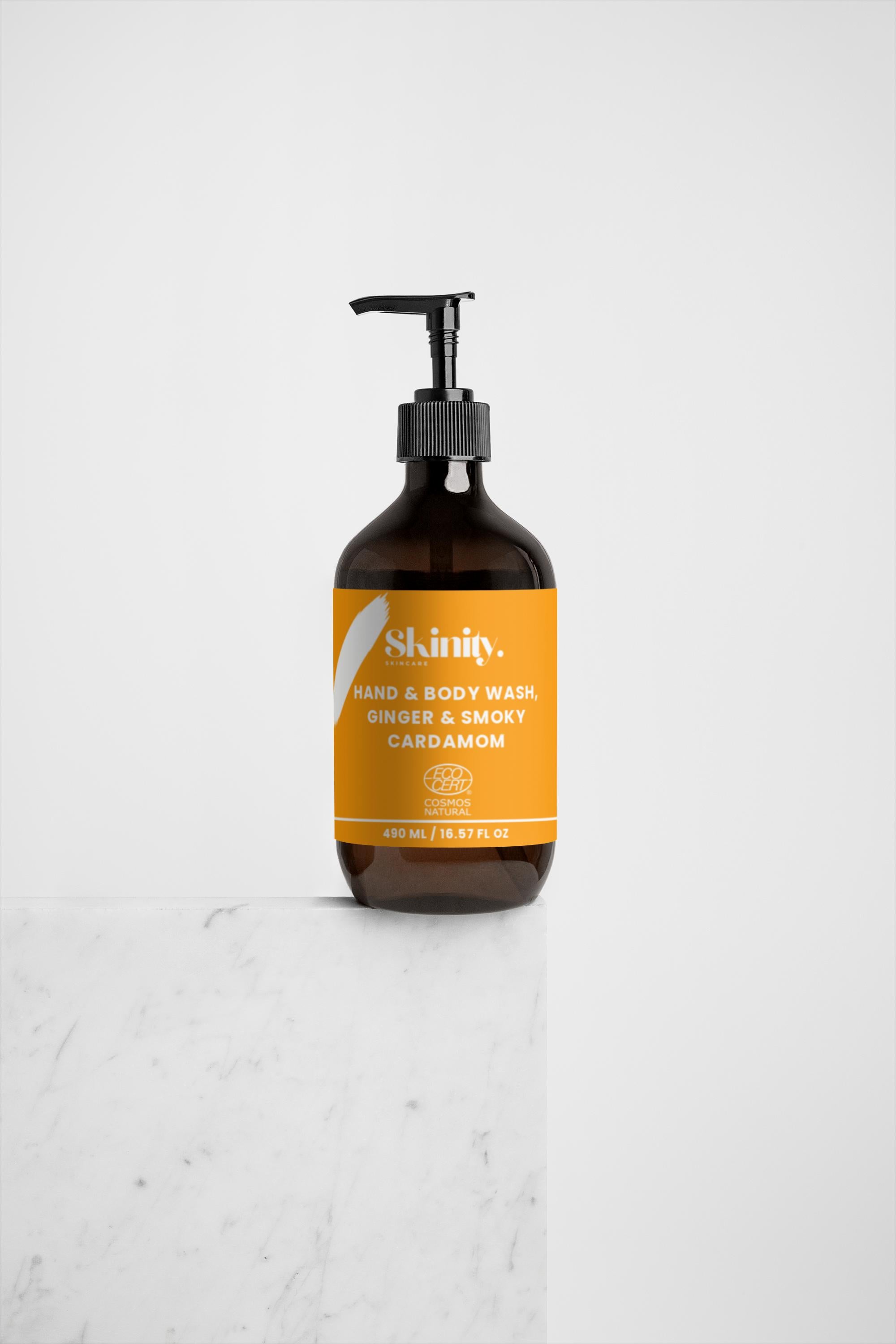 Hand and Body Wash Ginger and Smoky Cardamom in a stylish pump bottle on a marble surface.