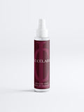 Hair mist bottle with black label on a white background
