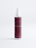 Hair mist bottle with black label on a white background