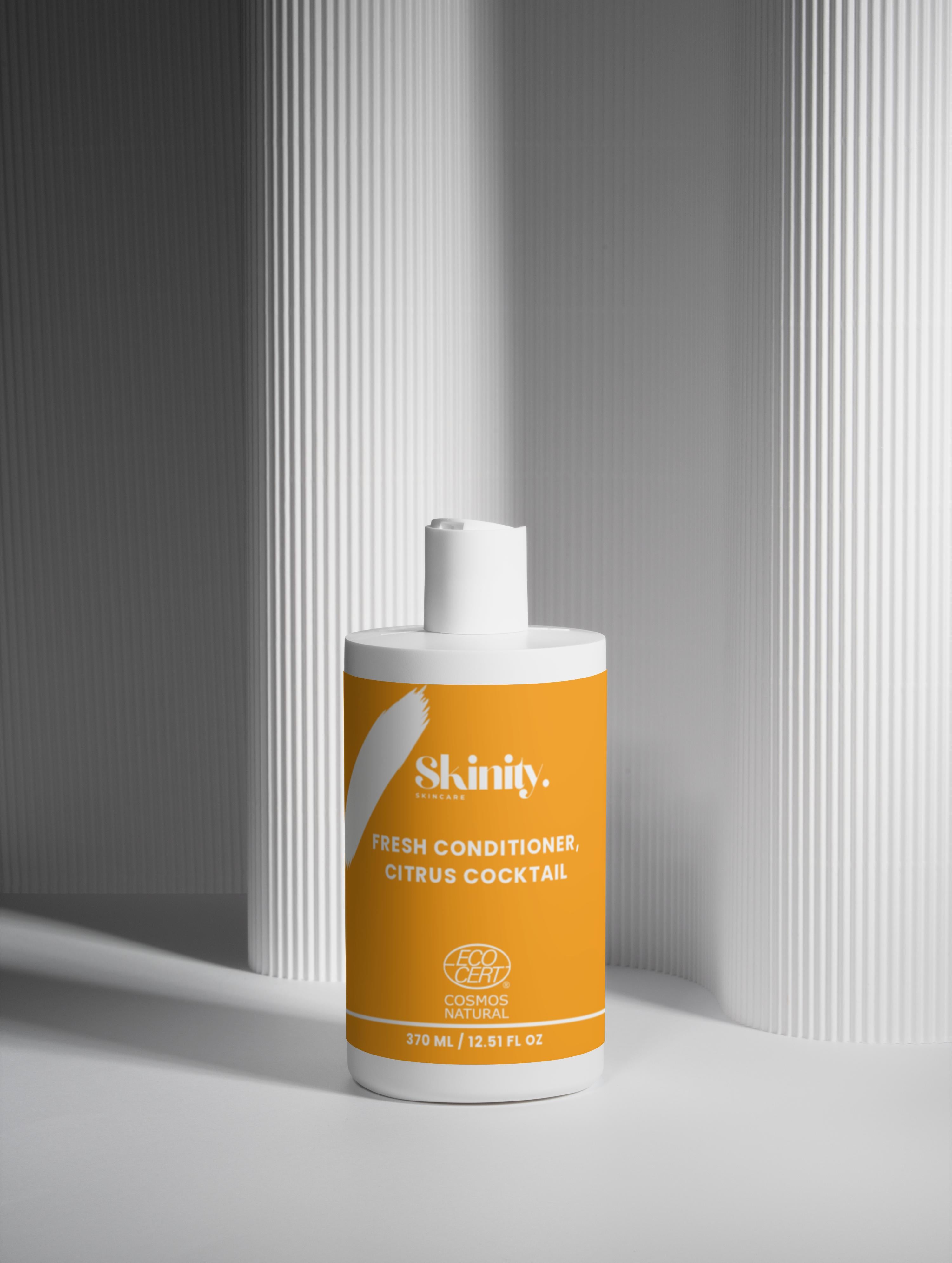 Fresh Conditioner Citrus Cocktail bottle on a minimalist background for hair nourishment and hydration.