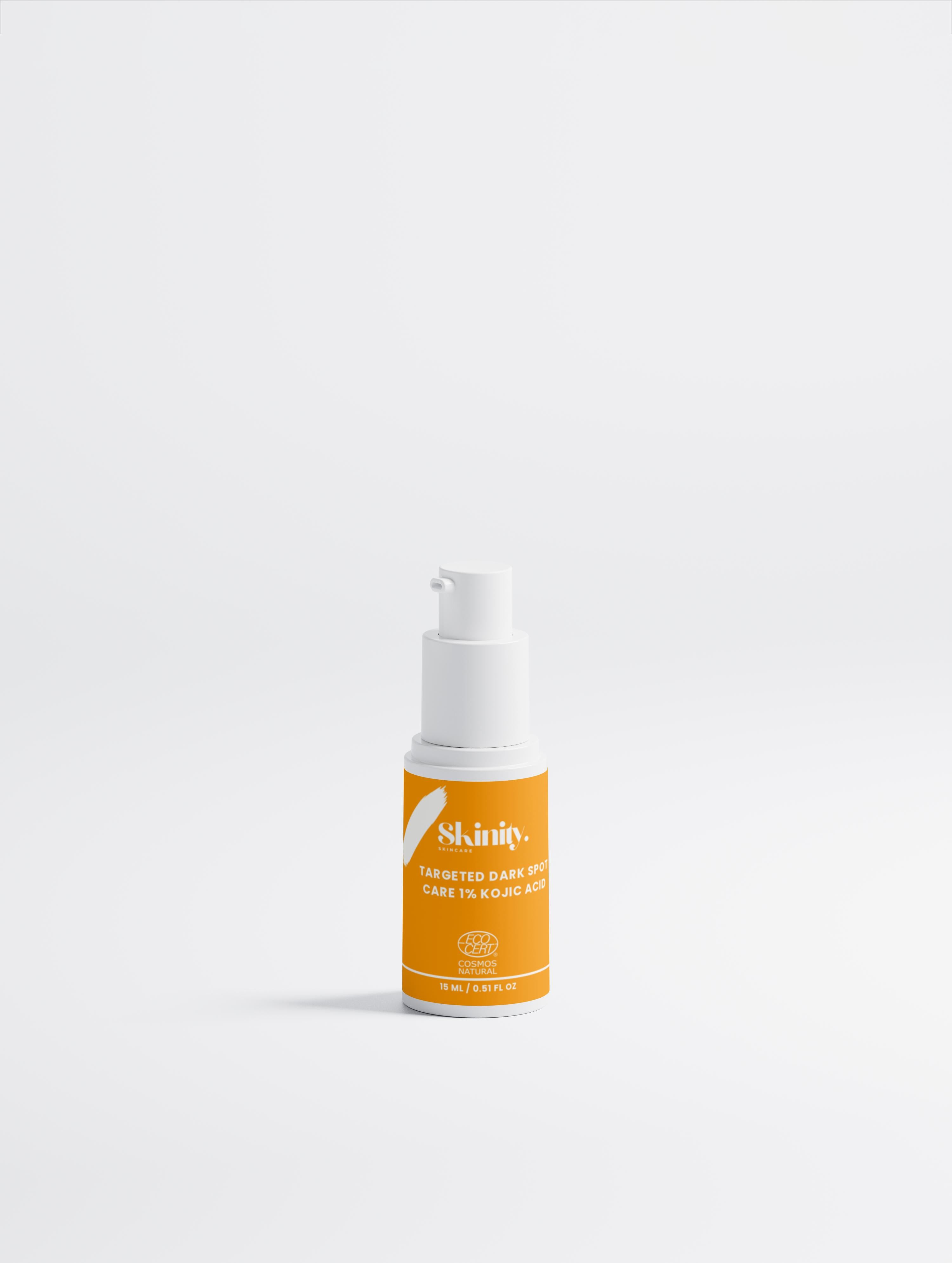 Kojic acid dark spot treatment in a clear bottle with an orange label for skin discoloration.