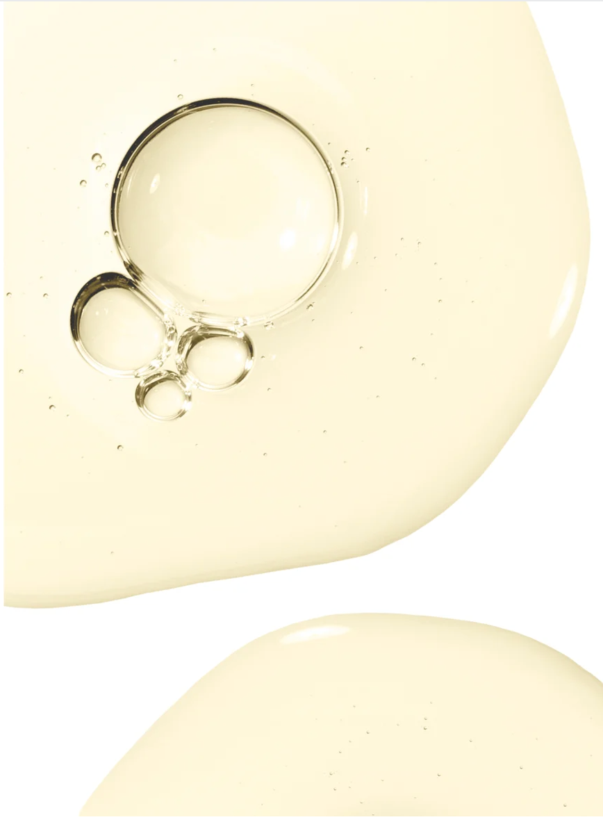 Rosemary Hair and Scalp Strengthening Oil texture shown in a smooth golden liquid with bubbles.