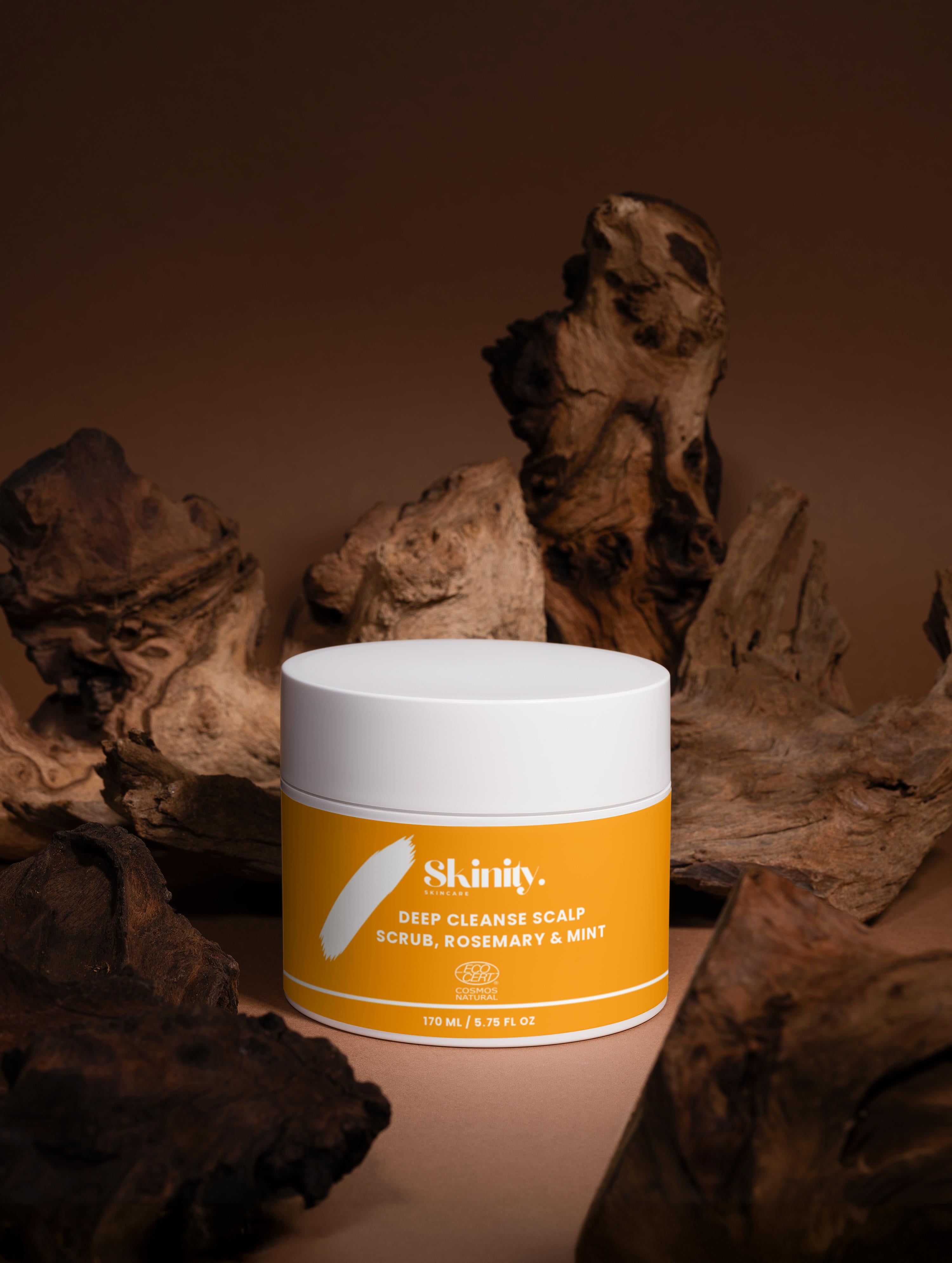 Deep Cleanse Scalp Scrub Rosemary and Mint jar on display with natural wood background.