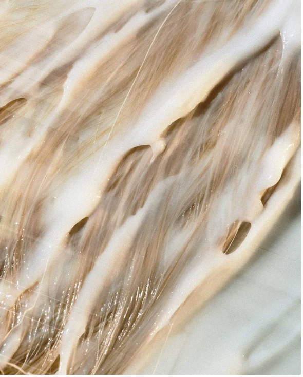 Moisturising Conditioner for all Hair types applied to blonde hair, providing hydration and nourishment.