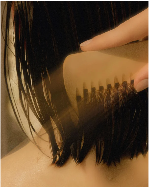 Applying Moisturising Shampoo for all Hair types, gently combing through damp hair to enhance moisture and shine.
