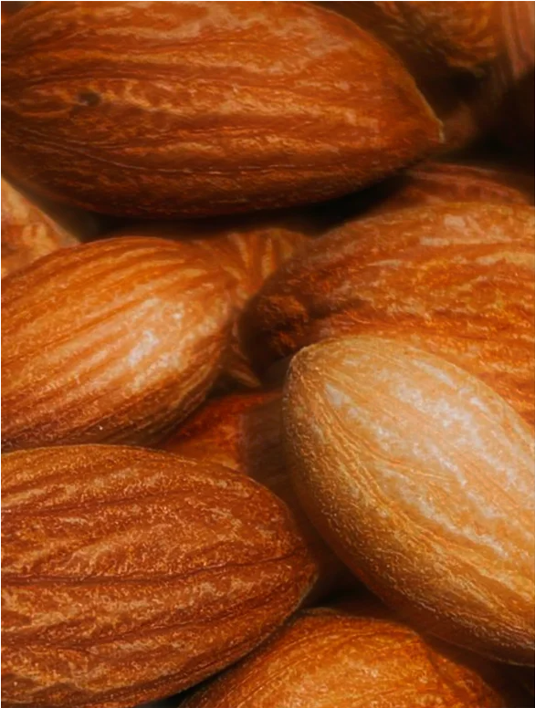 Close-up of roasted almonds showing textured brown surfaces and varying shapes.
