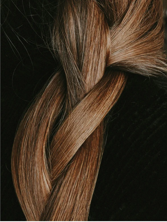 Close-up of a beautiful braid with shiny, healthy hair, showcasing natural texture and color.