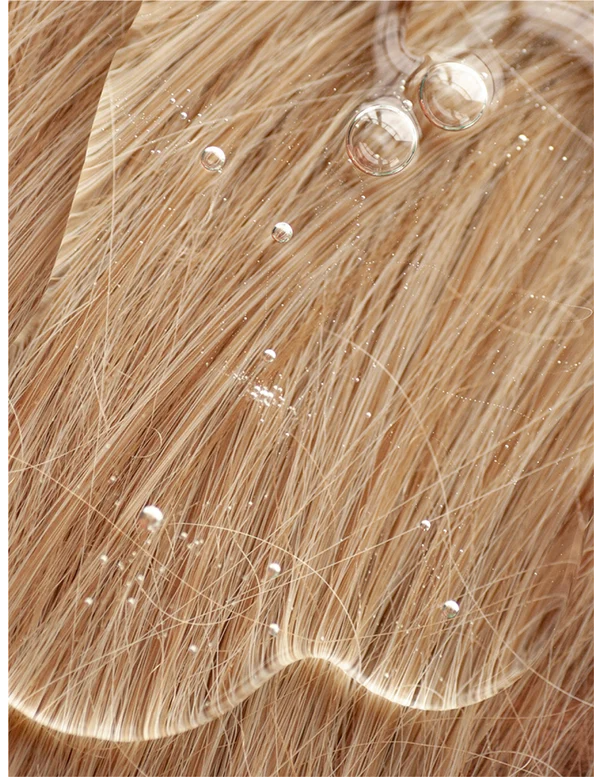 Sensitive Scalp Shampoo for all Hair Types on a textured hair surface with water droplets.