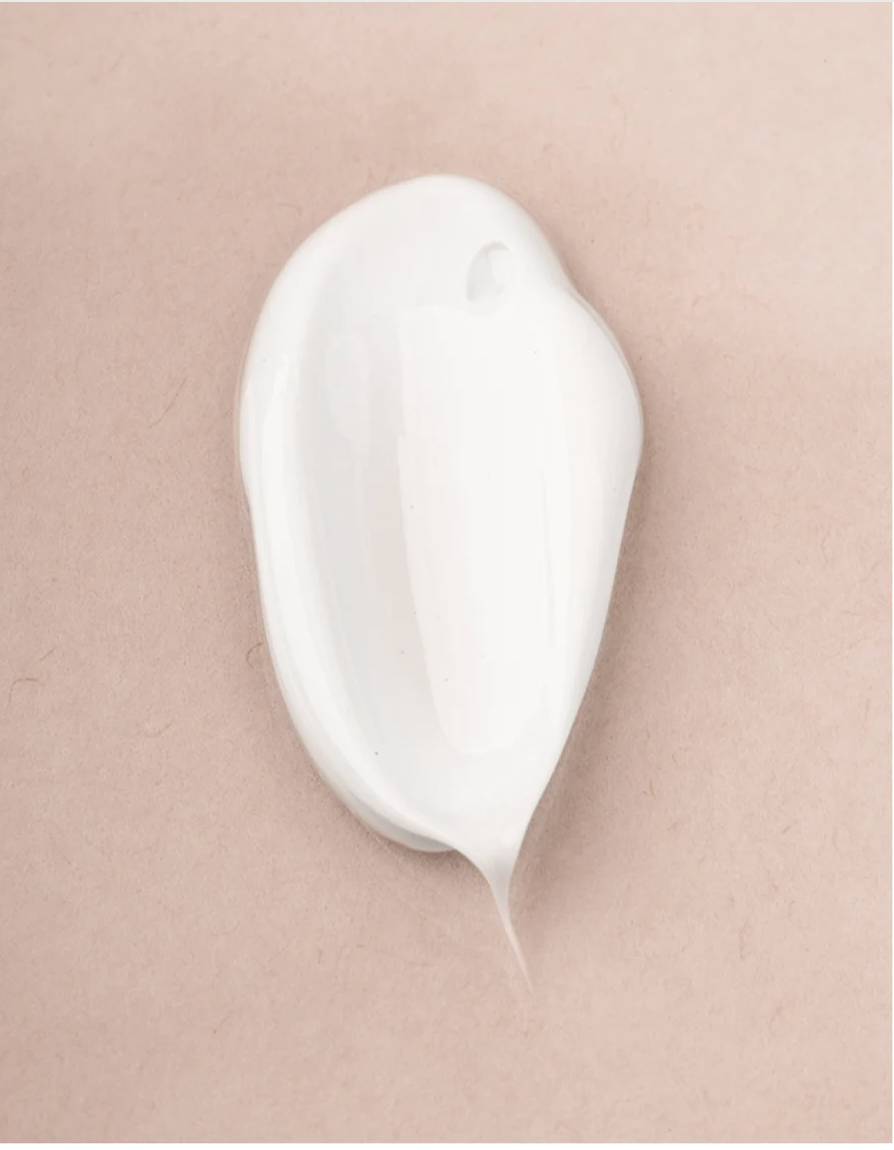 Sensitive Skin Body Cream Vegan cream texture on a light background, showcasing its smooth and hydrating formula.