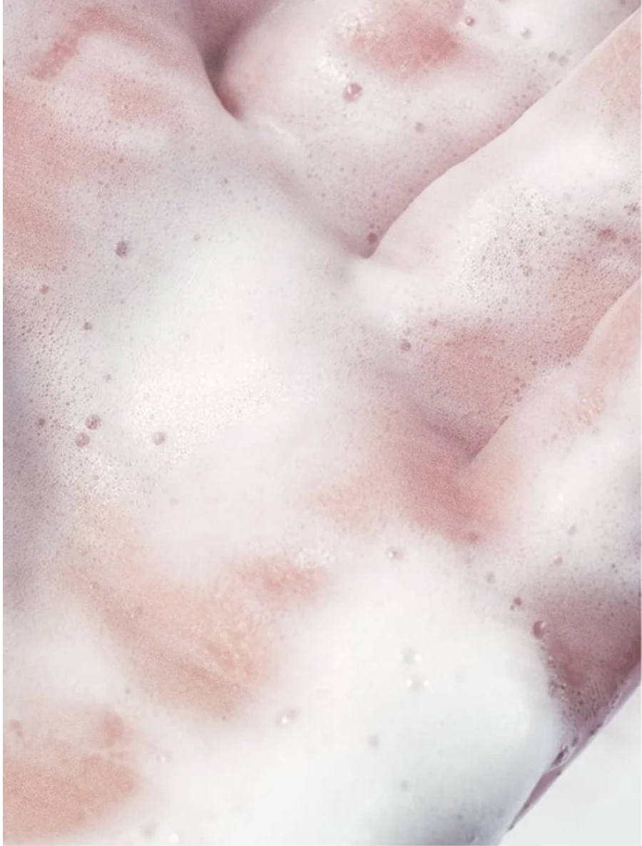 Sensitive Skin Face and Body Cleanser lather on hands, showcasing gentle, bubbly texture for delicate skin.