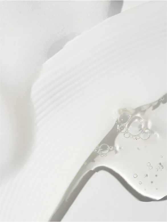 Sensitive Skin Face and Body Cleanser showcases a gentle, foamy texture for delicate skin types.