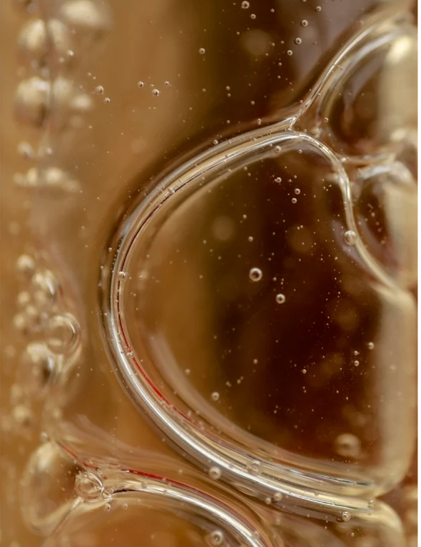 Close-up of bubbles in a clear liquid, showcasing movement and texture.