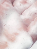 Sensitive Skin Face and Body Cleanser lather on hands, showcasing gentle, bubbly texture for delicate skin.