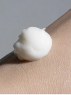 Silk Skin Hand Cream Woody Amber and Leather on a hand, showcasing creamy texture for hydration and nourishment.