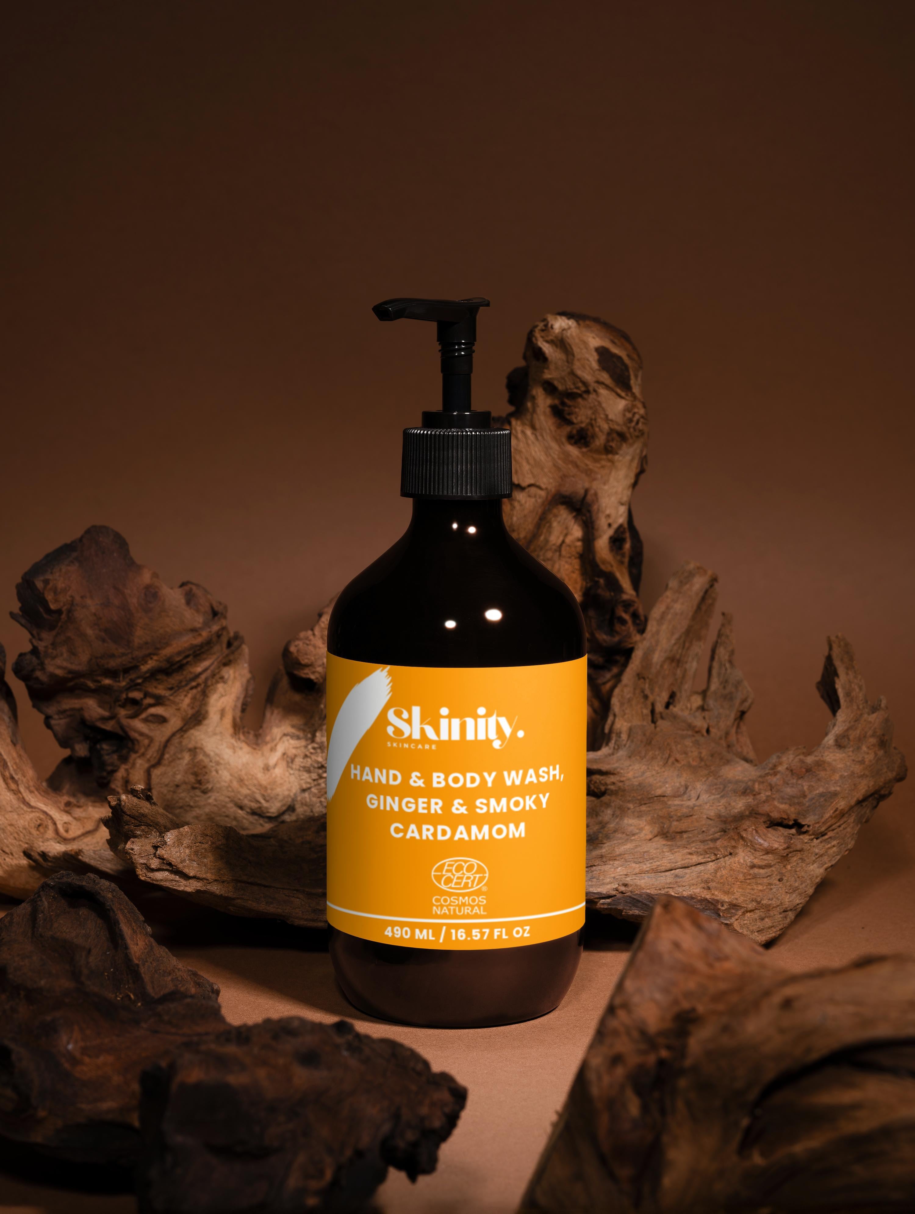 Hand and Body Wash Ginger and Smoky Cardamom bottle on wooden display, showcasing its luxurious packaging and rich scent.