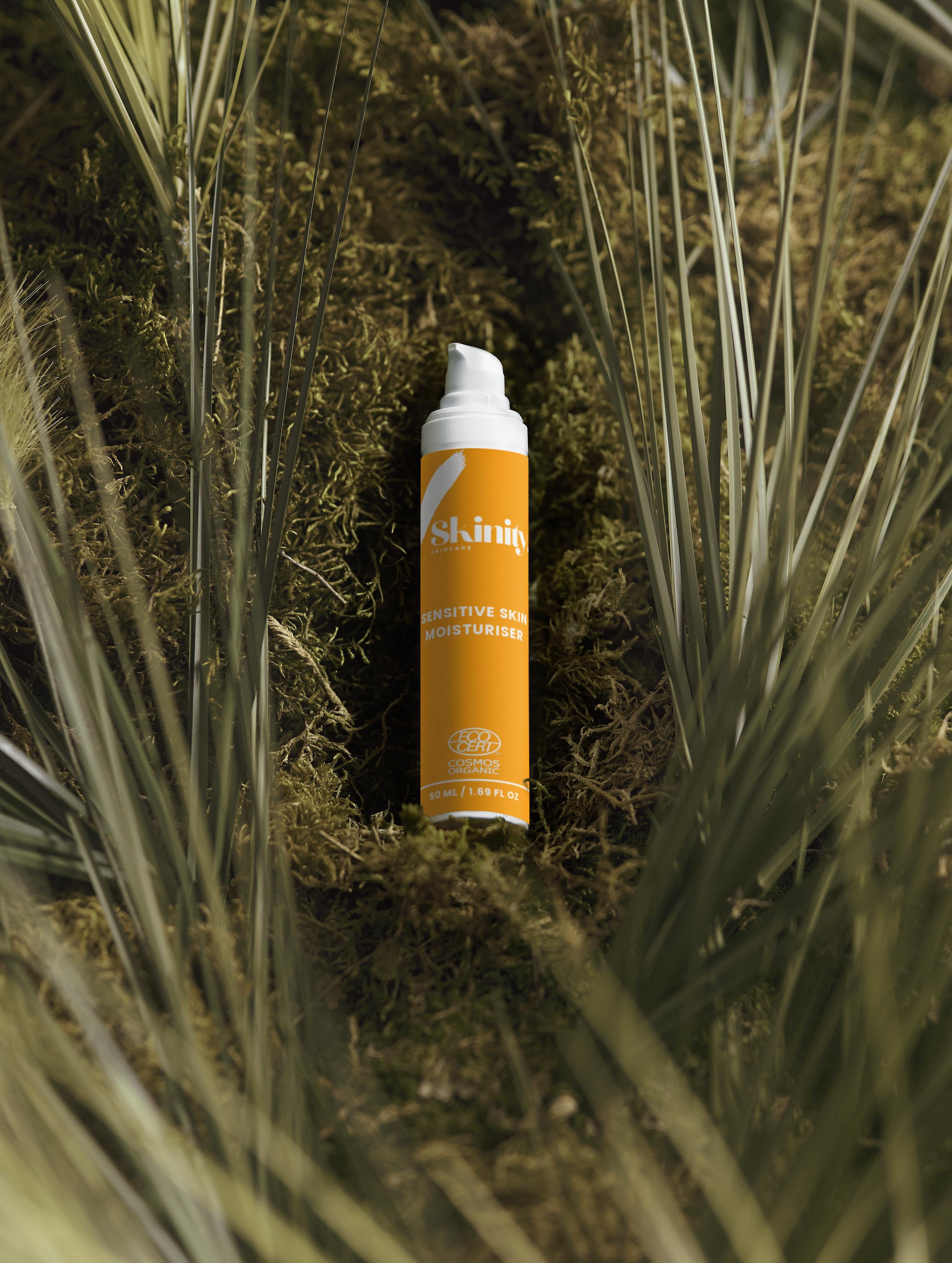Sensitive Skin Moisturiser Fragrance Free bottle on moss surrounded by green leaves