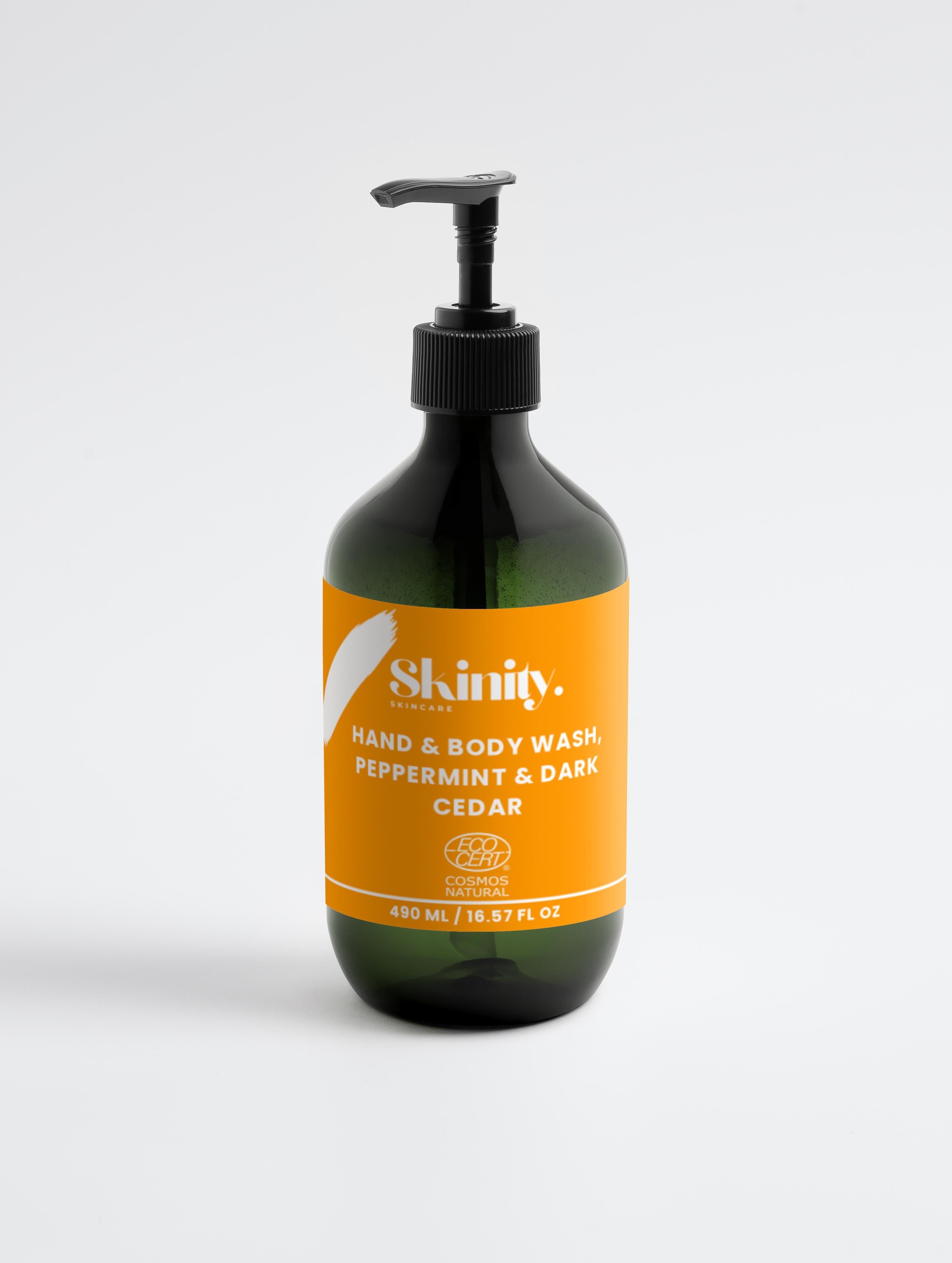 Hand and Body Wash Peppermint and Dark Cedar in a dark pump bottle with a vibrant orange label.