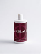 A bottle of Le Célaire Fresh Conditioner in Citrus Cocktail scent, featuring a deep burgundy label with white lettering and a white cap, set against a clean white background.