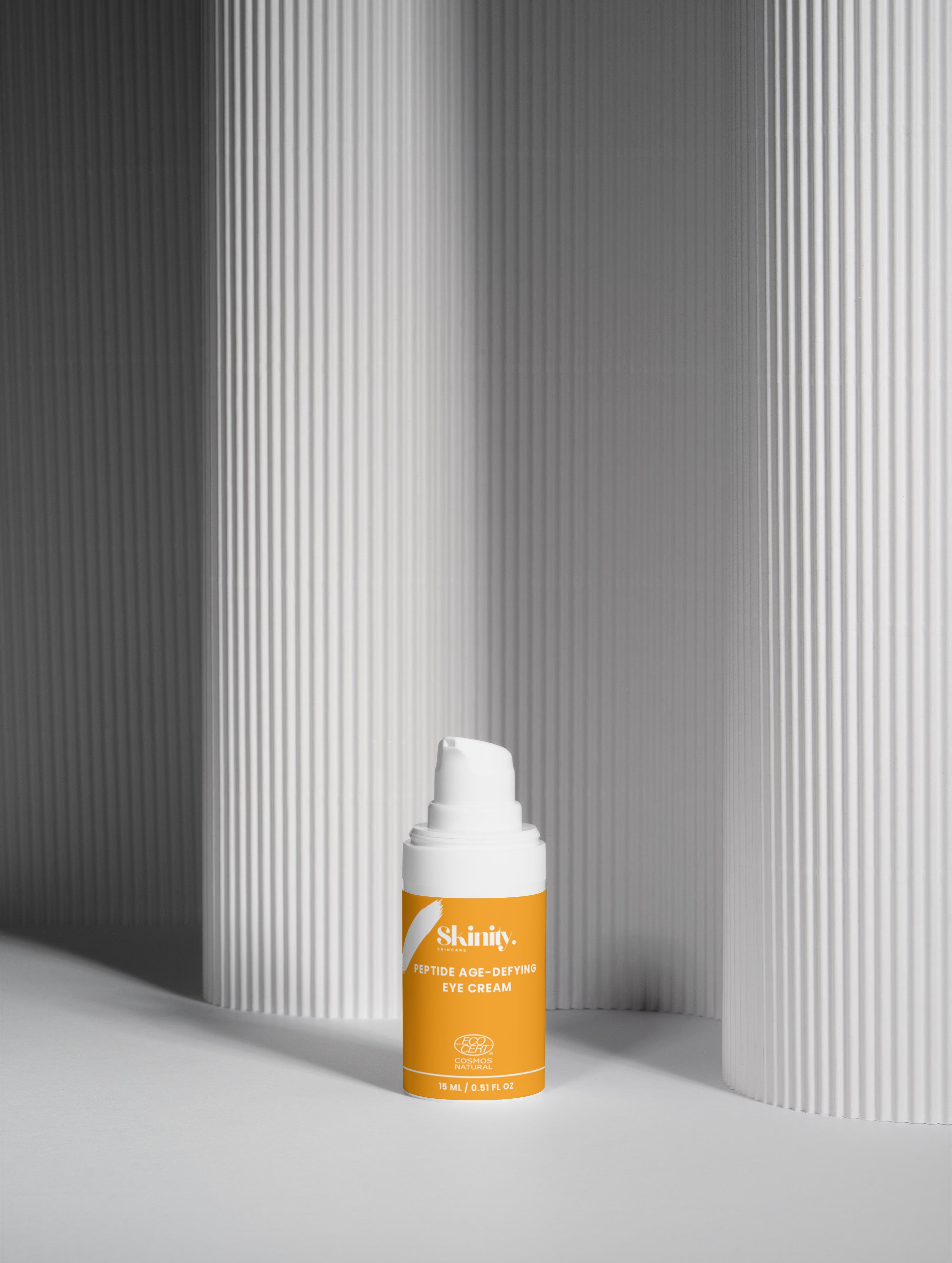 Skinity Skincare Peptide Anti Aging Eye Cream for Wrinkles and Dark Circles premium product bottle placed on an organic luxury dark wood texture background with natural greenery elements