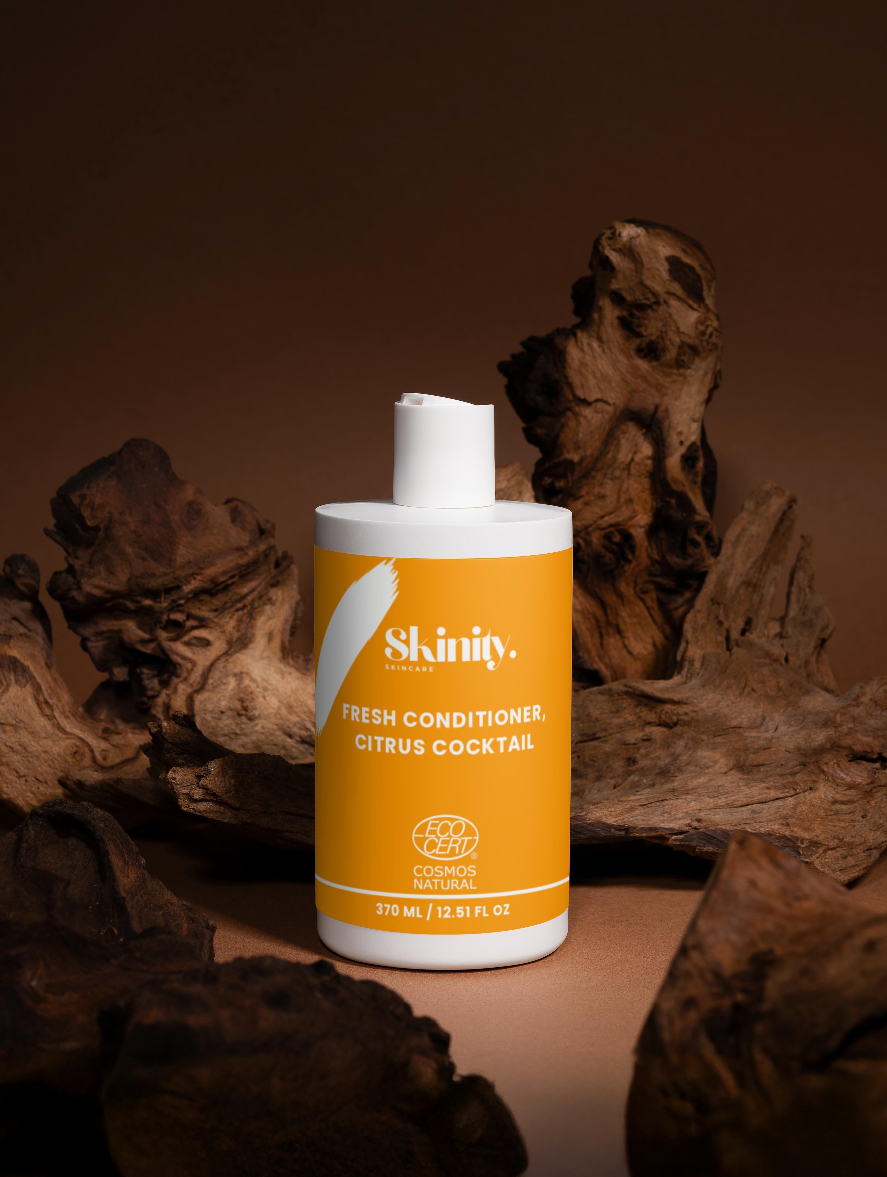 Skinity Fresh Conditioner Citrus Cocktail bottle on wooden background, promoting hair nourishment and hydration.