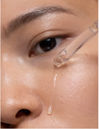 AHA Peeling Concentrate For Skin being applied to a woman's cheek for brighter, smoother skin.