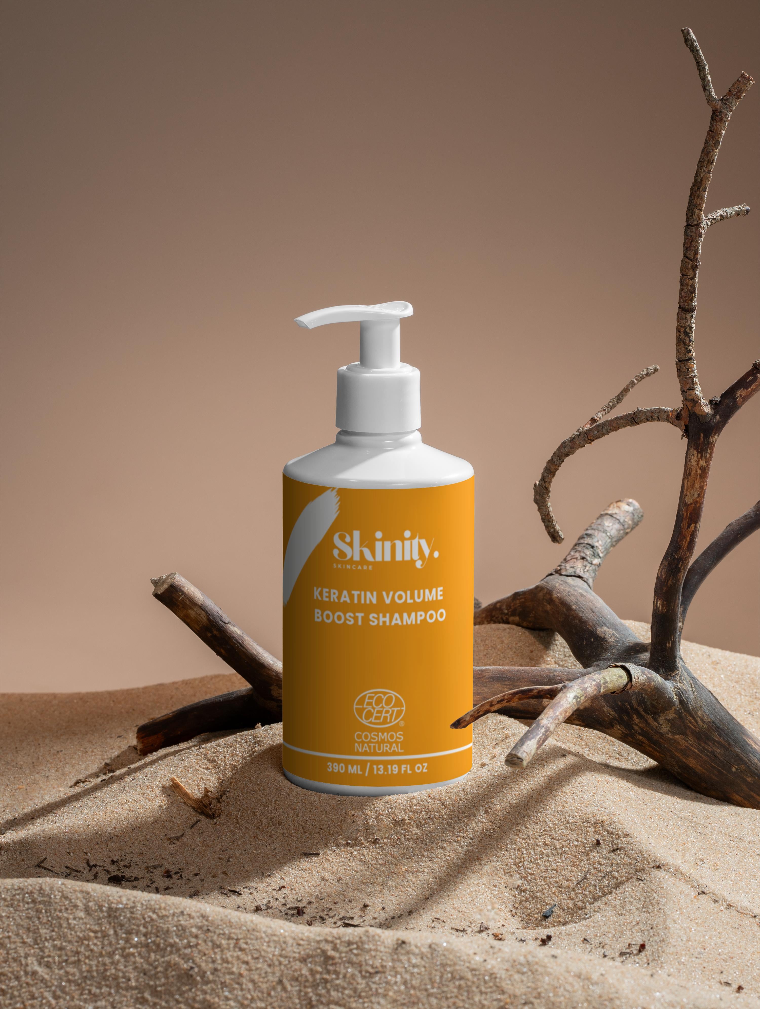 Keratin Volume Boost Shampoo for All Hair Types bottle on sand with branches in the background