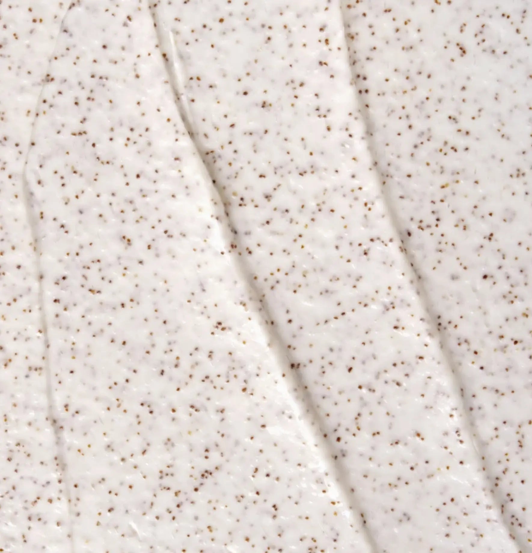 Le Célaire Deep Cleanse Scalp Scrub creamy white texture swatch with fine crushed sour cherry shell particles