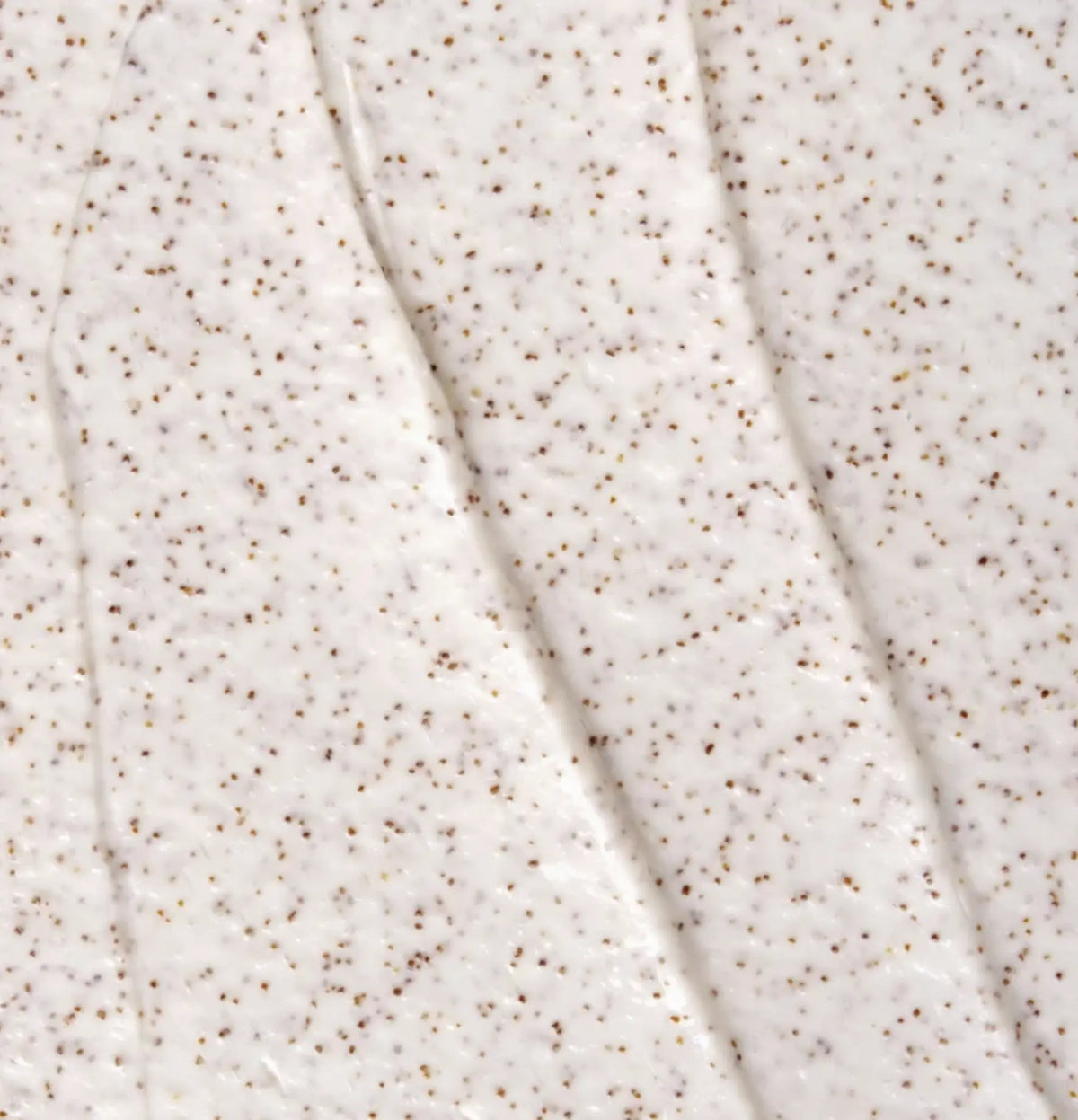 Le Célaire Deep Cleanse Scalp Scrub creamy white texture swatch with fine crushed sour cherry shell particles