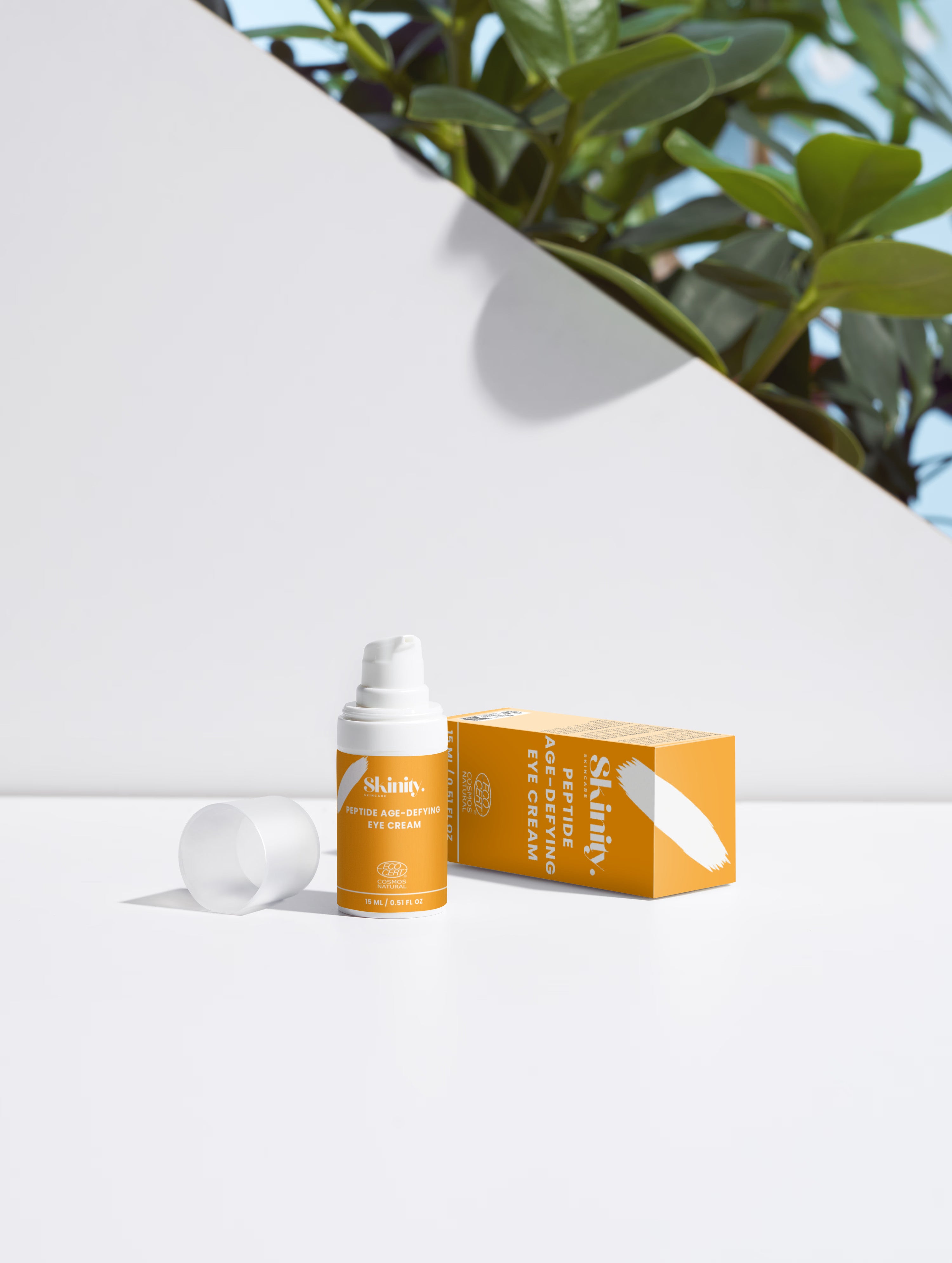 Skinity Skincare Peptide Anti Aging Eye Cream for Wrinkles and Dark Circles premium product bottle placed on an organic luxury dark wood texture background with natural greenery elements
