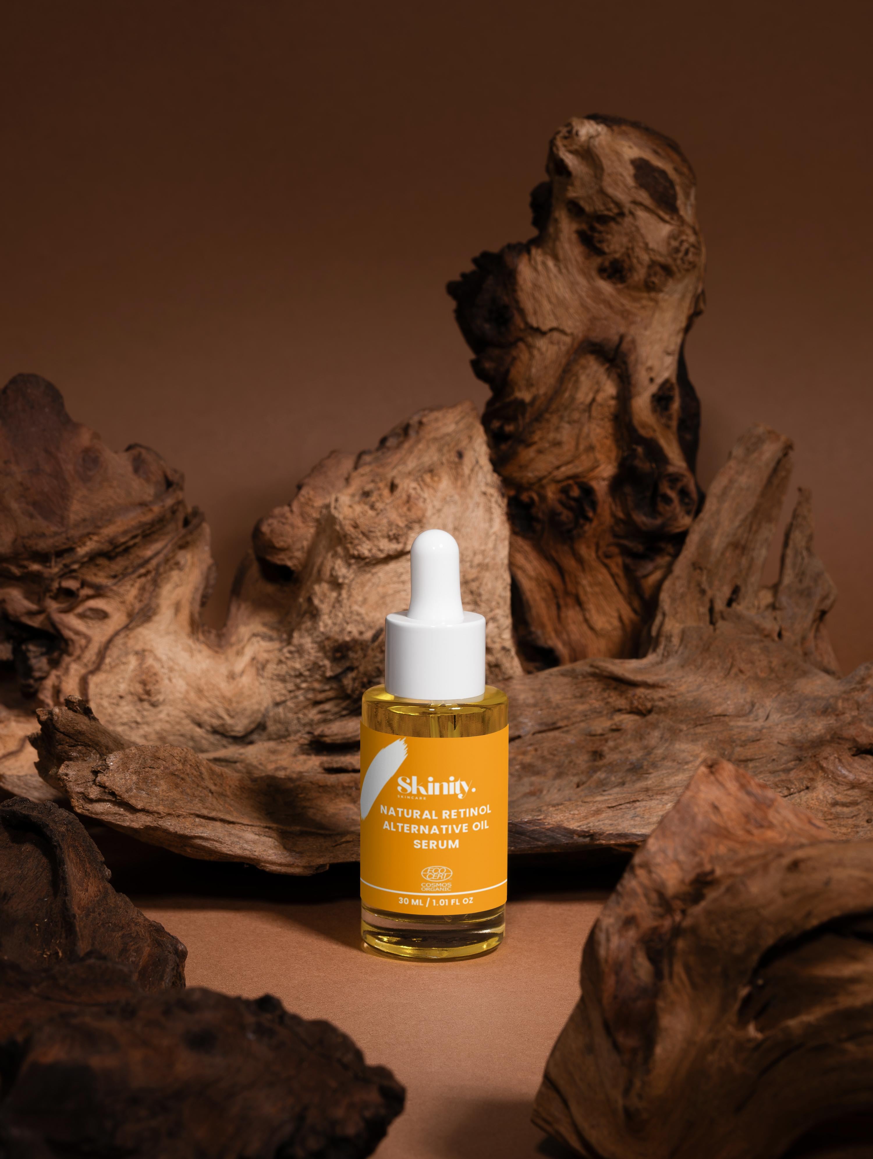 Natural Retinol Alternative Oil Serum in a dropper bottle on a wooden background.