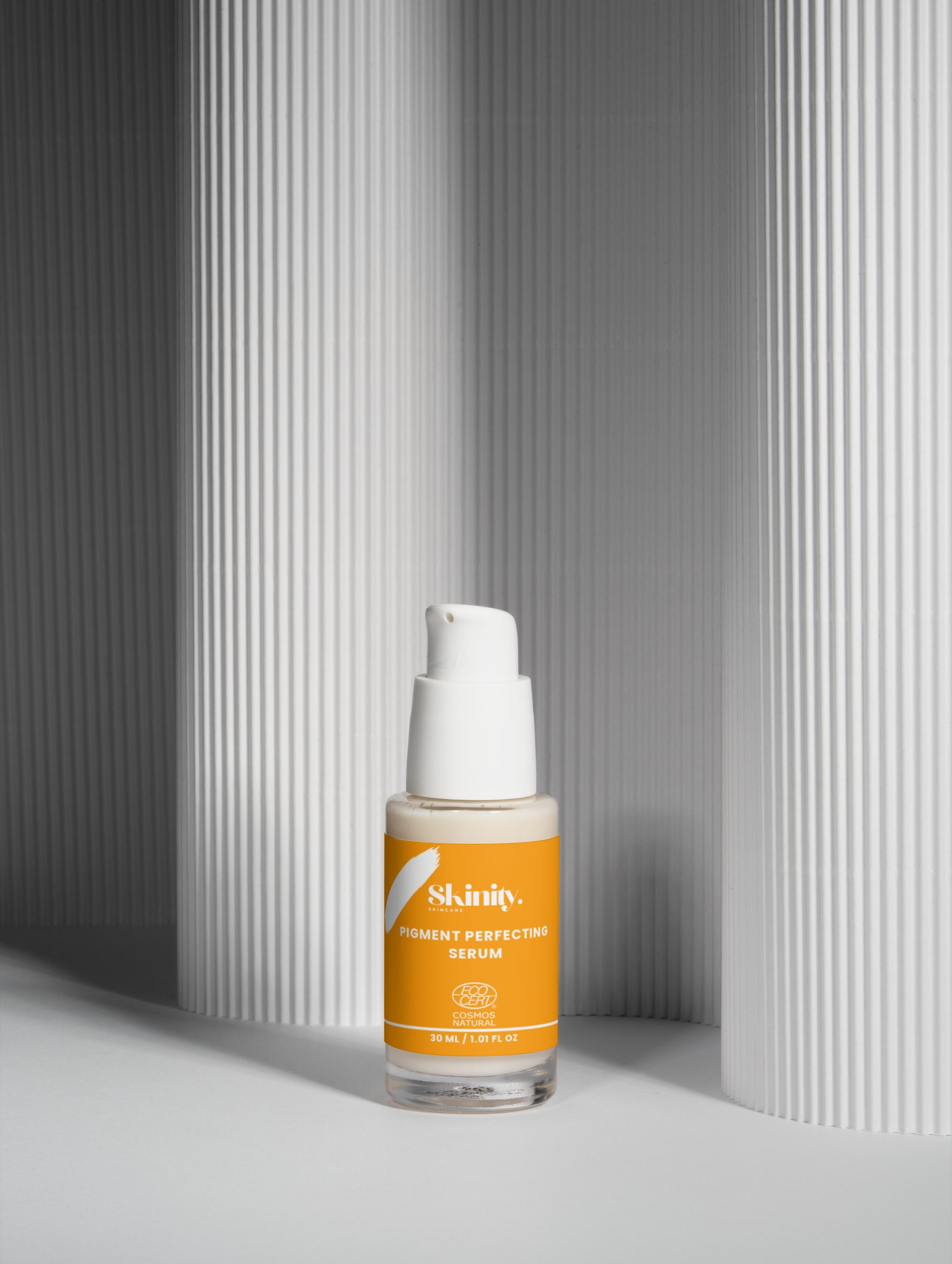 Pigment Perfecting Serum for All Skin in a sleek bottle, set against a minimalist background.
