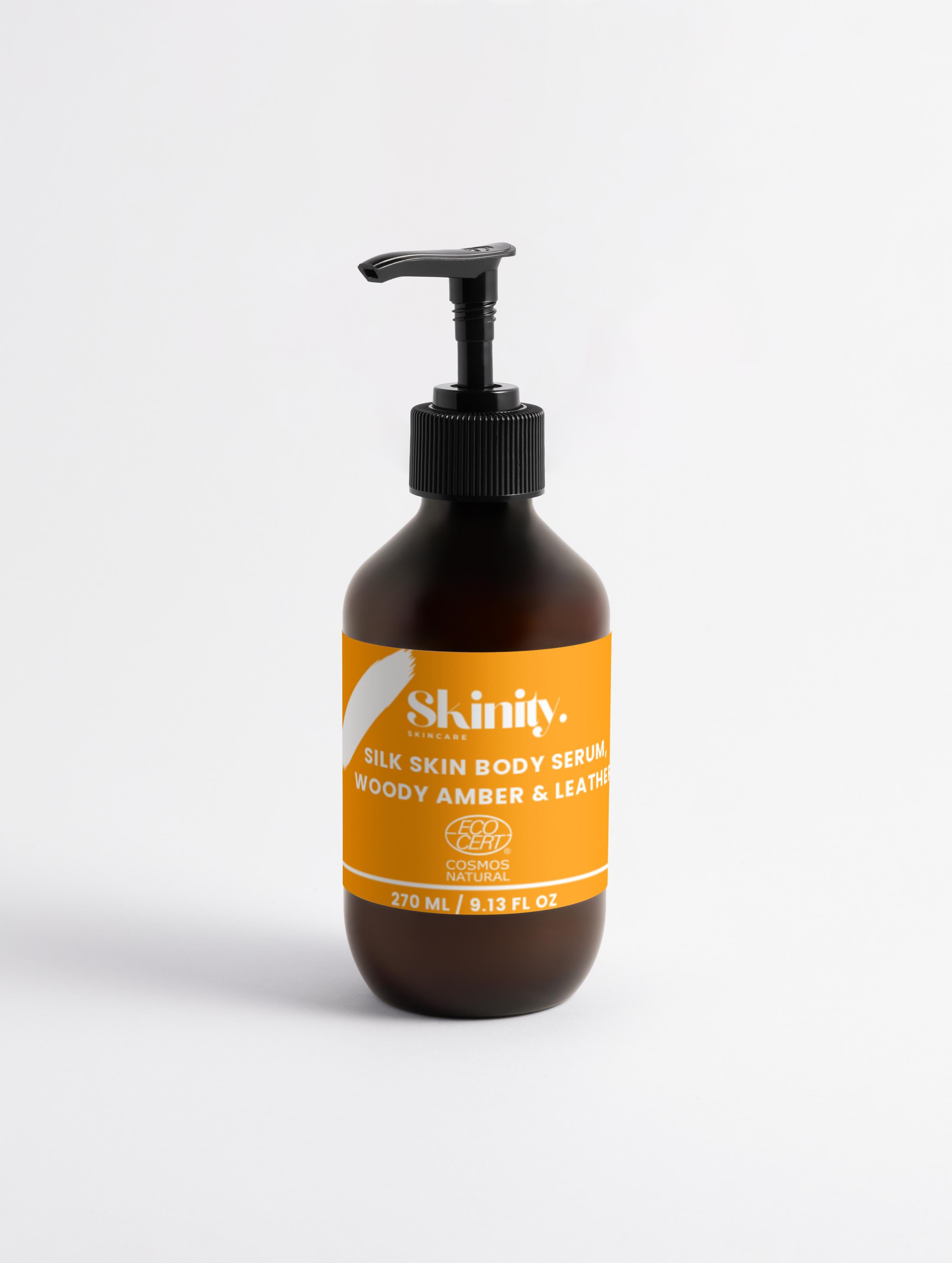 Silk Skin Body Serum Woody Amber and Leather in a pump bottle for deep hydration and soft skin.